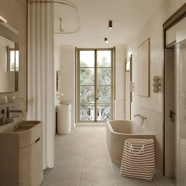 large gray foldable laundry basket with easy carry handles in the bathroom