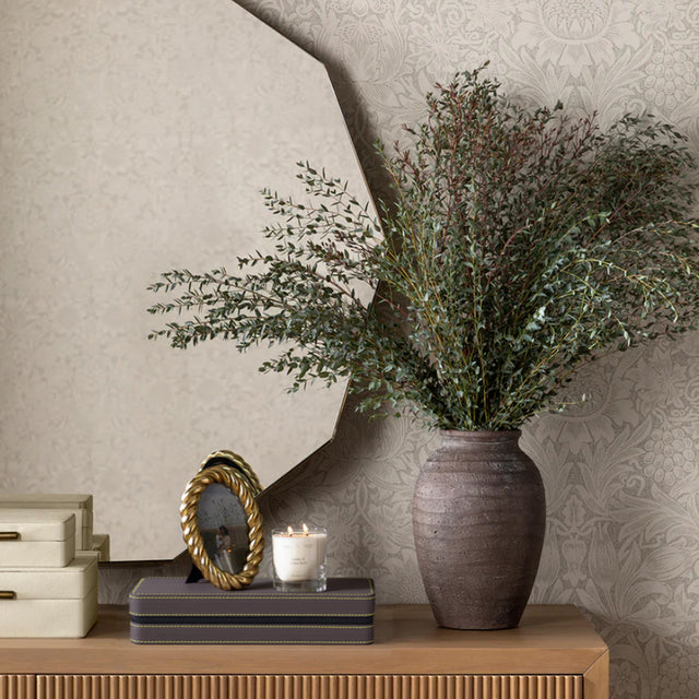 leather jewelry storage box placed underneath photo frame and candles