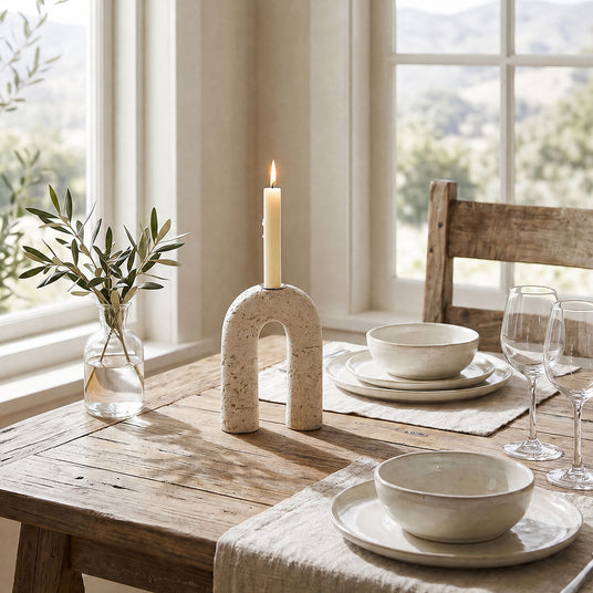 lit stone arch candle holder on dining table