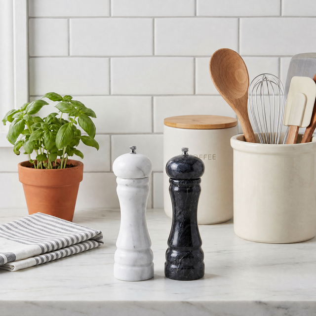 marble salt and pepper mills on white kitchen counter