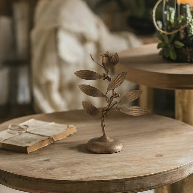 metal leaf candle holder on the wooden table