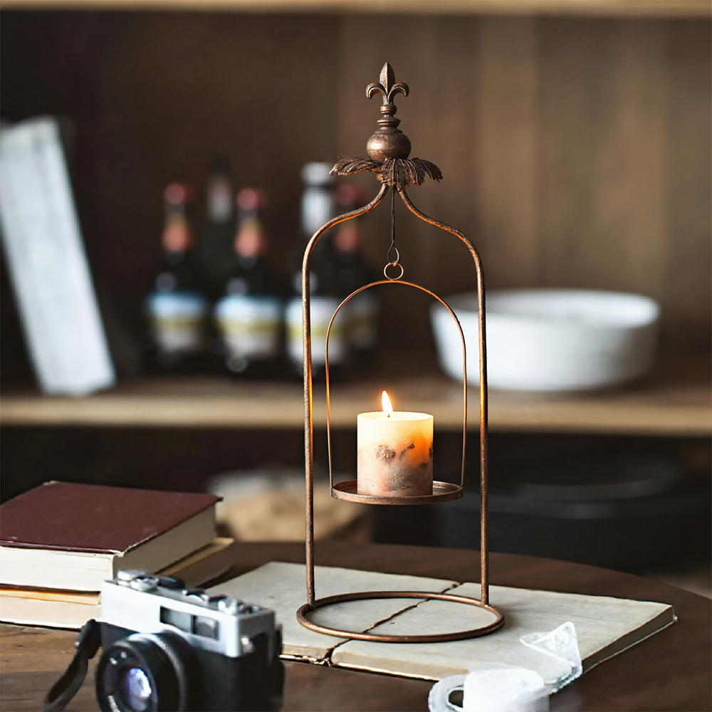 metal pillar candle holder on the table