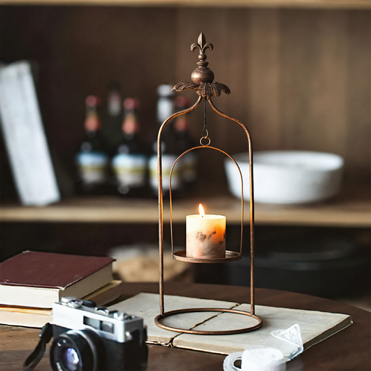 metal pillar candle holder on the table