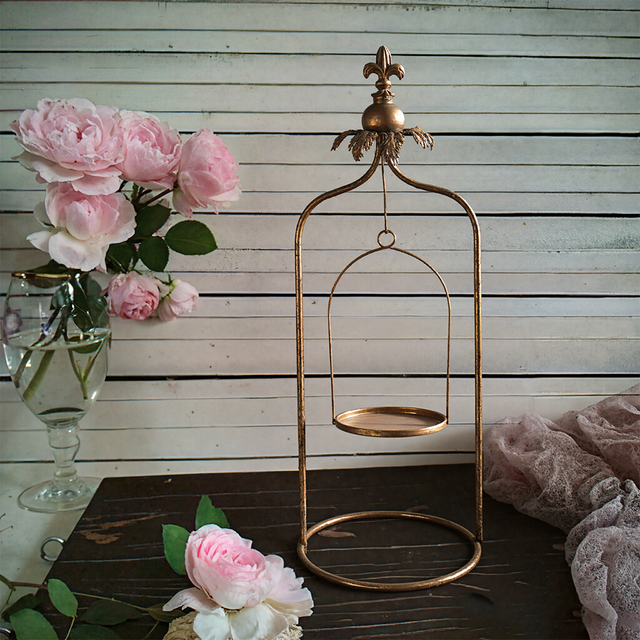 metal pillar candle holder on the table