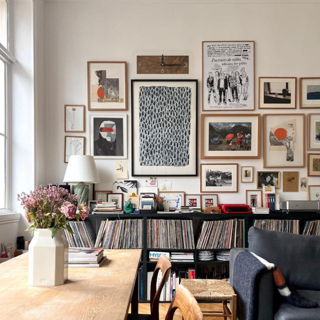 minimalist wooden rectangular digital wall clock beside the hanging painting