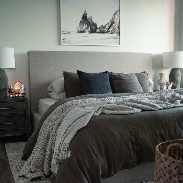 modern minimalist dark gray throw pillow on the bed