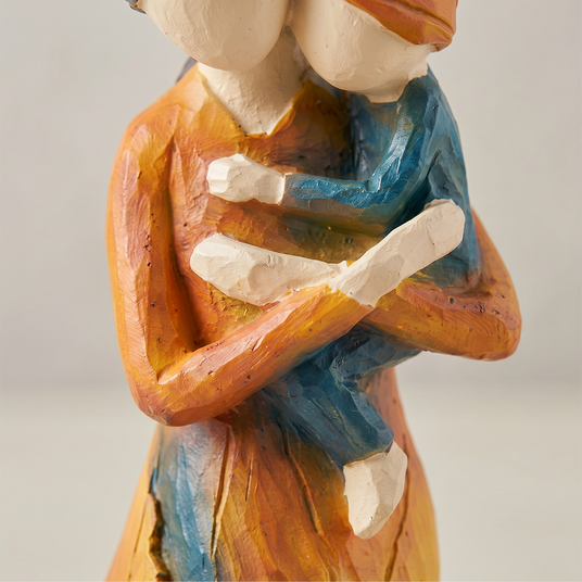 mother child figurine hands hugging detail