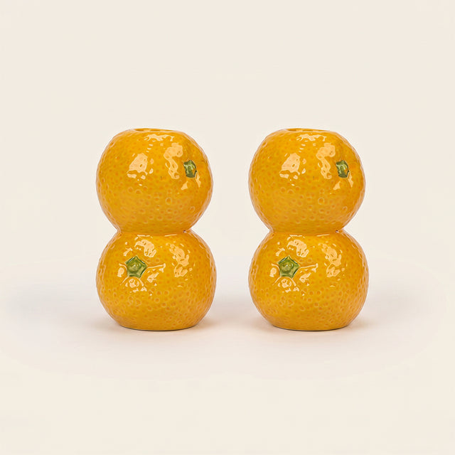 orange candle holder pair on white background