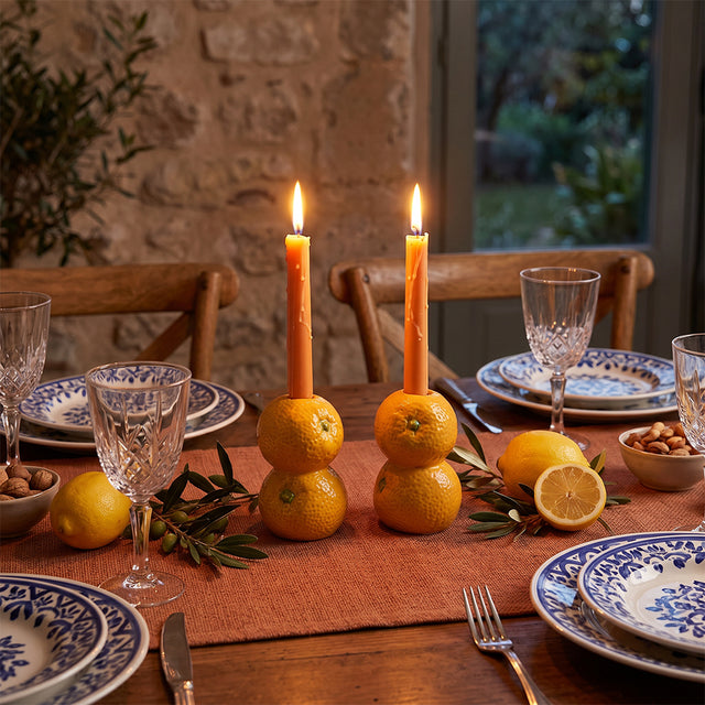 orange candle holders on rustic table setting