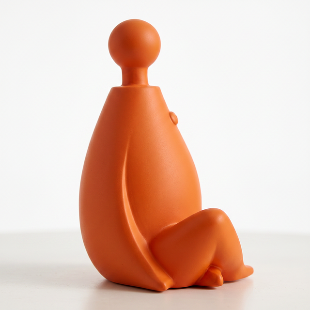 orange sitting figurine close up