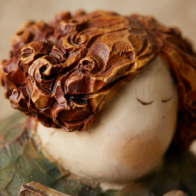 pebble figurine head with hat close up