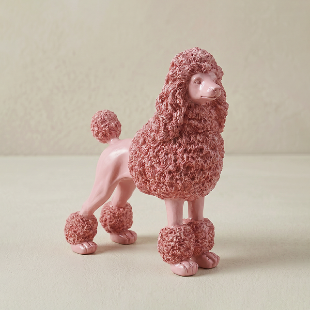 pink ceramic poodle sculpture on stand