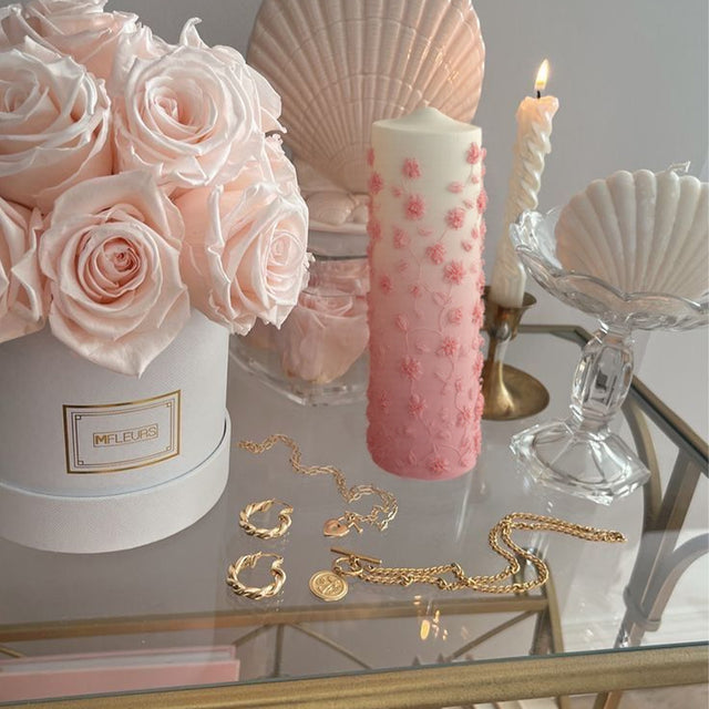 pink mold-poured candle on the glass coffee table