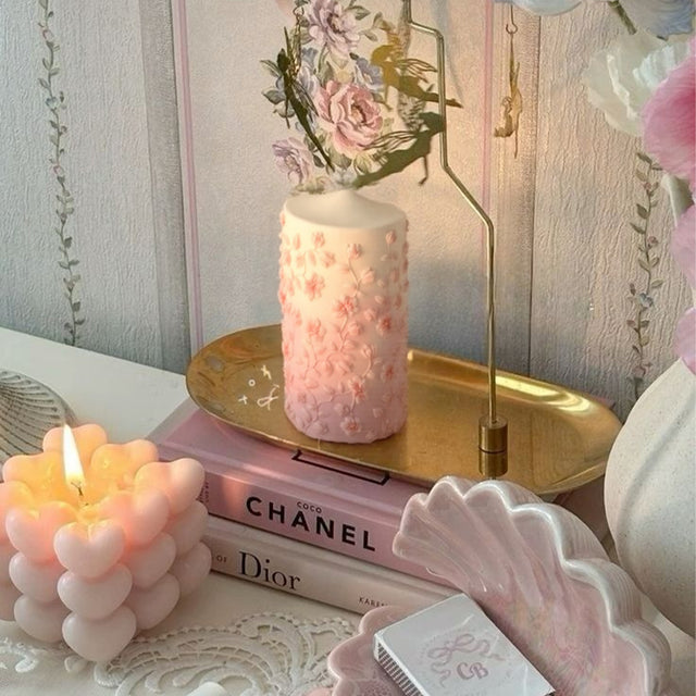 pink mold-poured candle on the golden tray