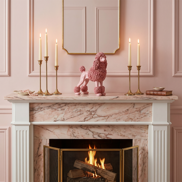 pink poodle on marble fireplace with candles