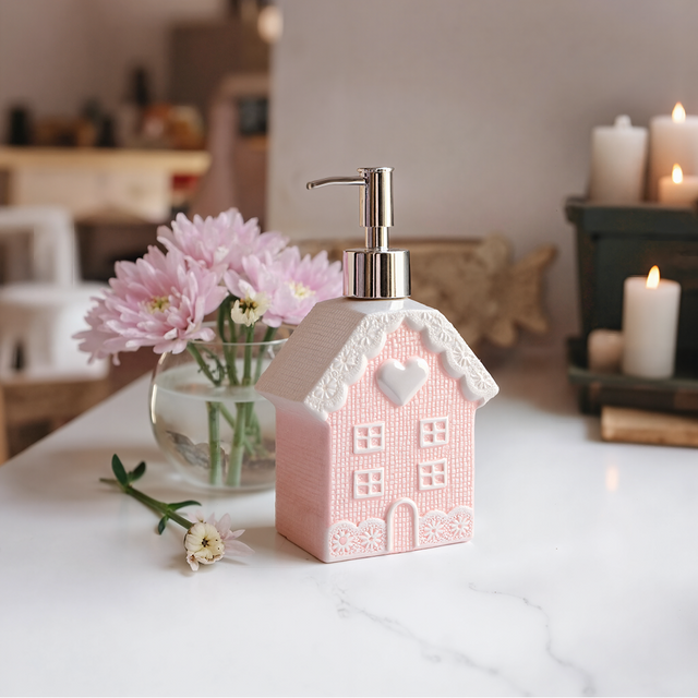pink soap dispenser on the table