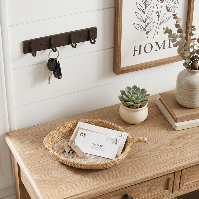 rattan tray with mail and keys on entryway table