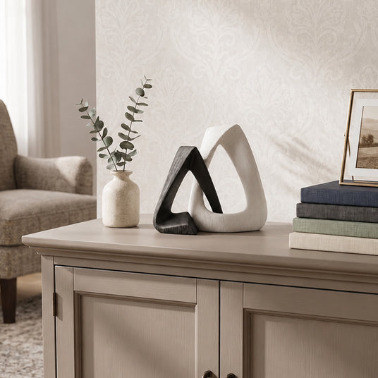 resin sculpture on sideboard with vase