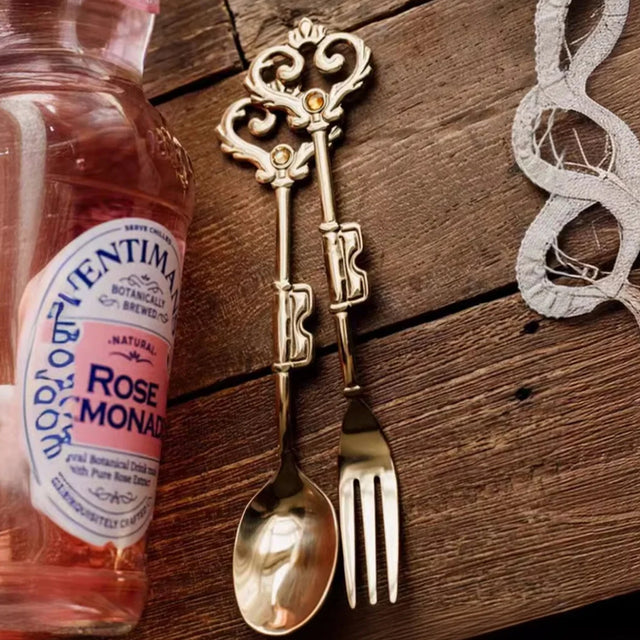 retro stainless steel golden key shaped fork and spoon on the table