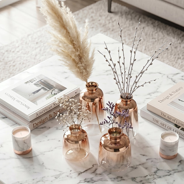 rose gold vases with flowers on coffee table