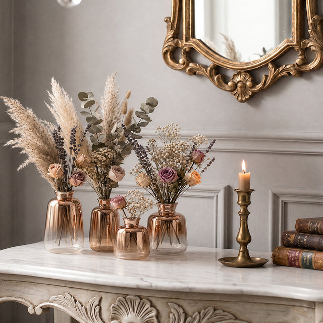 rose gold vases with pampas and dried roses on marble