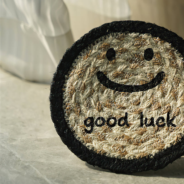 round jute woven smiling face table coaster details