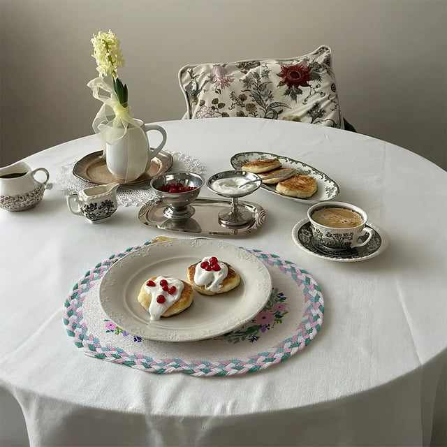 rustic floral woven oval placemat with food