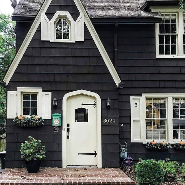 rustic green mailbox hanging near the front door