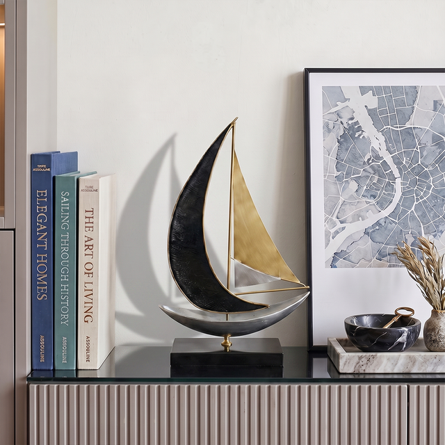 sailboat sculpture on grey console