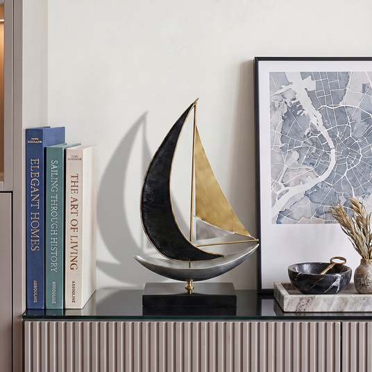 sailboat sculpture on grey console