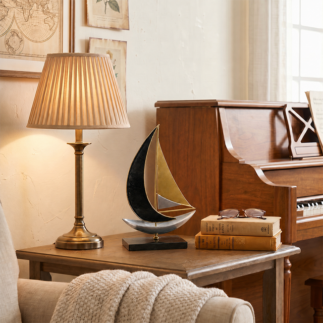 sailboat sculpture on wooden side table