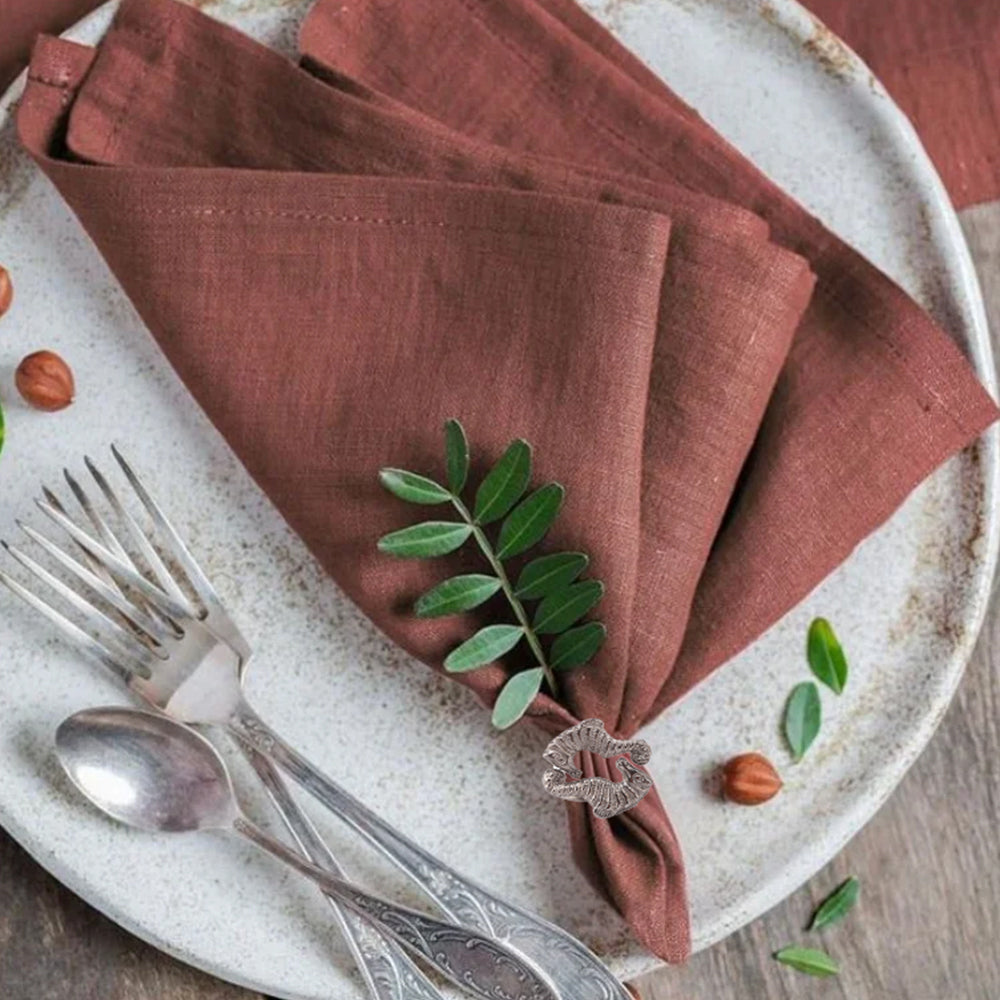 seahorse napkin ring holding cloth napkin