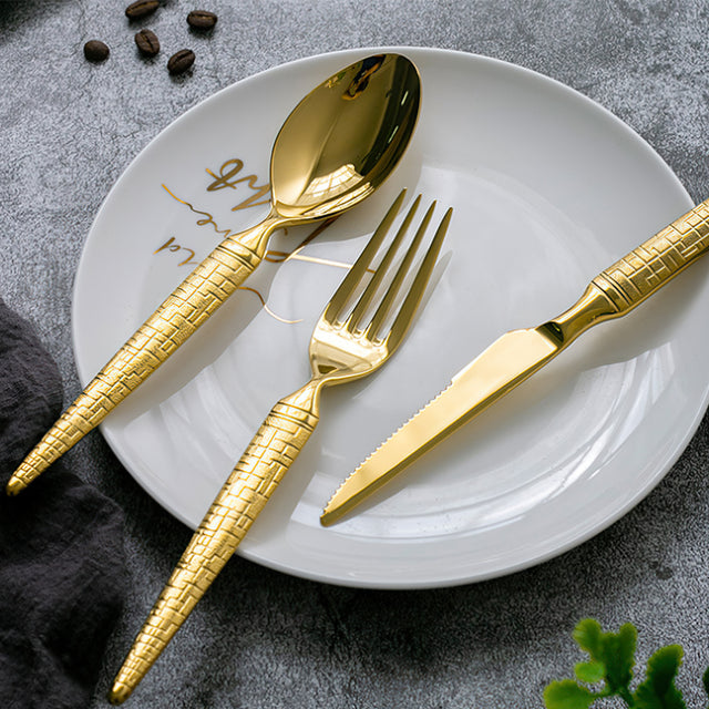 set of 3 stainless steel golden tableware on the plate