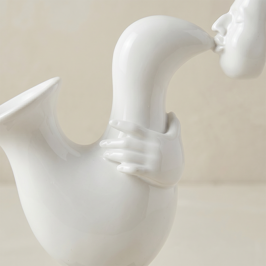 side view of white saxophone sculpture with hand