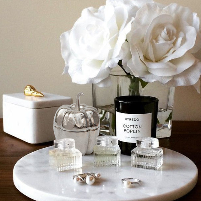 silver pumpkin shaped decorative storage jar on a tray
