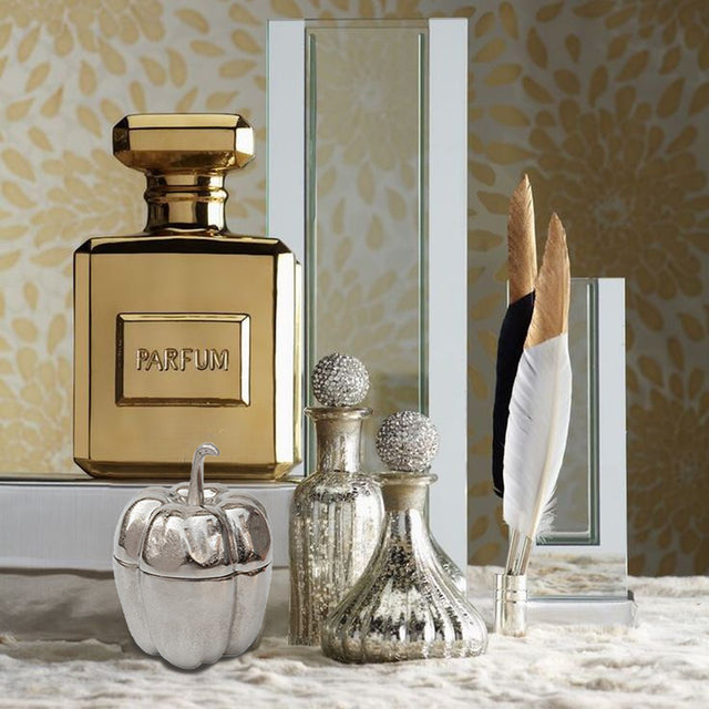 silver pumpkin shaped decorative storage jar on vanity table