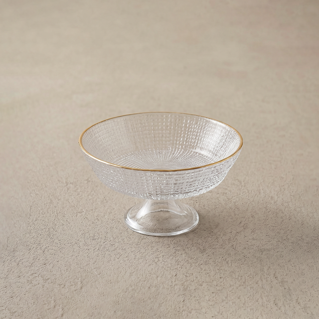 small glass bowl on beige surface
