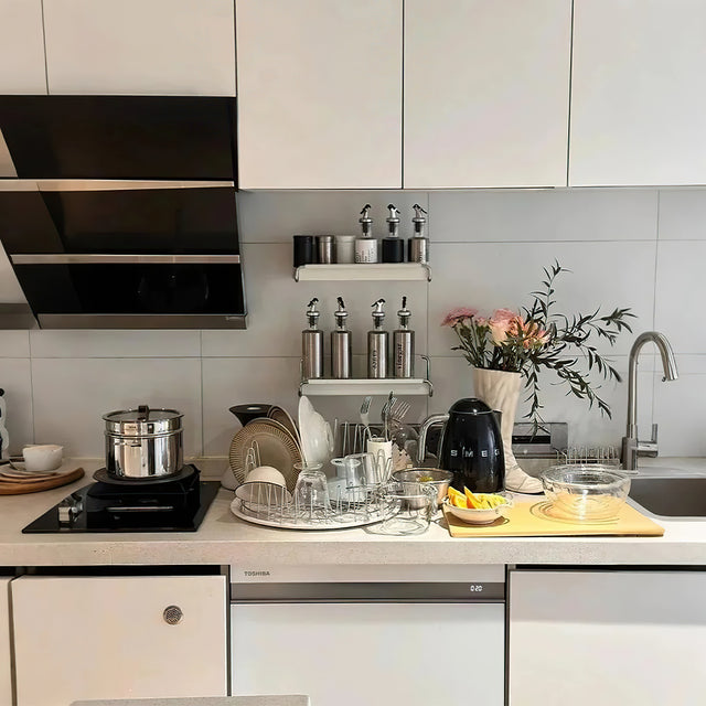 stainless steel dish drying rack with tray in the sink area