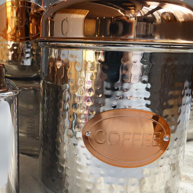 stainless steel sealed coffee storage canister with a pineapple handle details