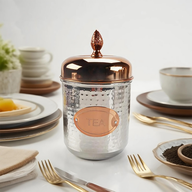 stainless steel sealed tea storage canister with a pineapple handle on the dining table