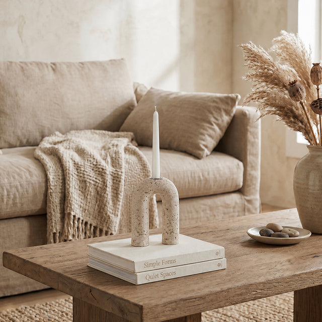 stone arch candle holder on books on coffee table