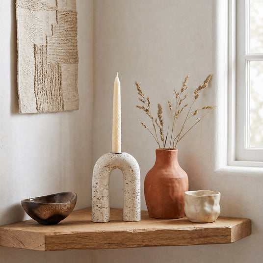 stone arch candle holder on wooden shelf