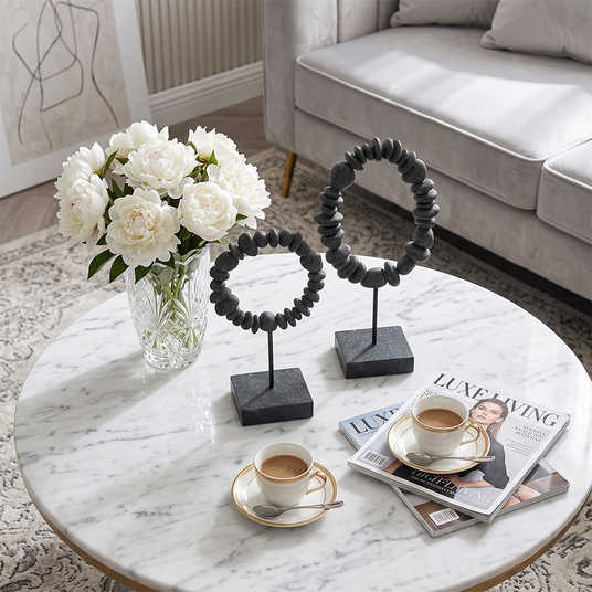 stone ring sculptures on marble table