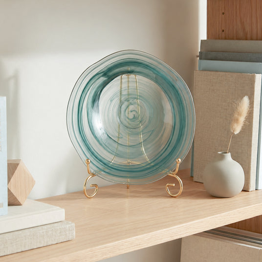 teal round glass decorative plate on gold stand