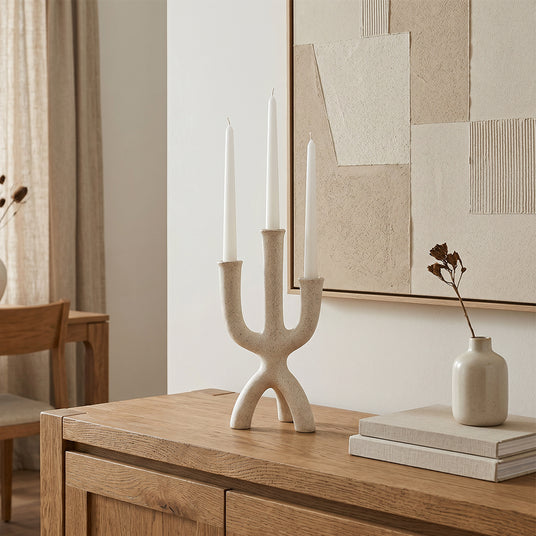 textured candle holder on light wood cabinet