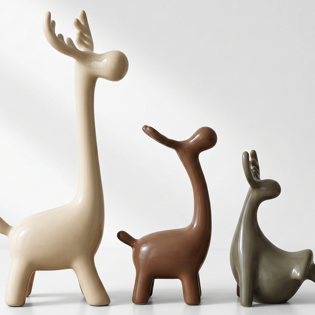 three ceramic deer lineup white background