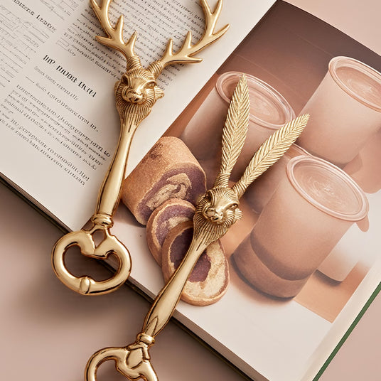 two brass decorative bottle openers on a book