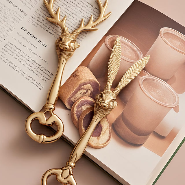 two brass decorative bottle openers on a book