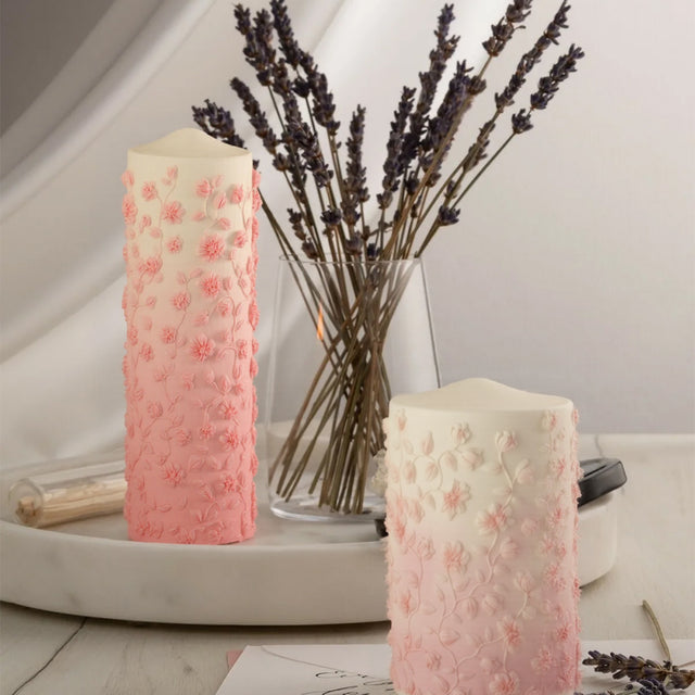 two pink mold-poured candles on the table