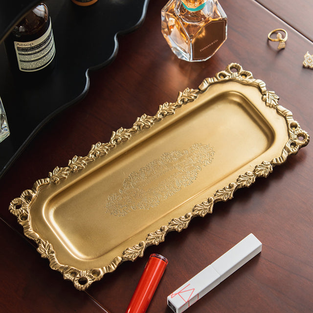 vintage carved brass floral design serving tray on the table